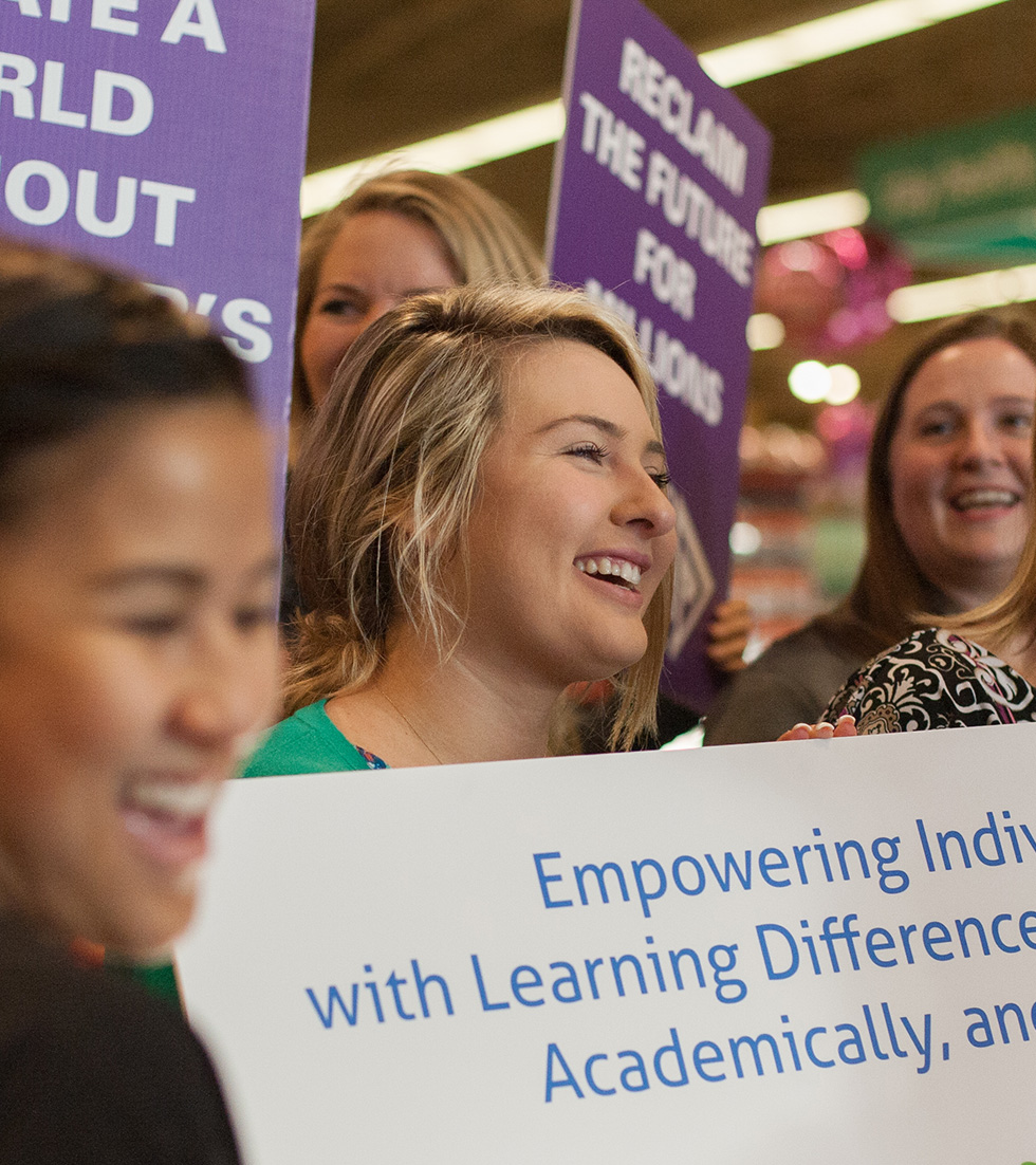 Several women smiling and picketing to make a postive impact