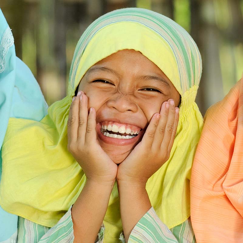 A girl wearing a headdress smiling